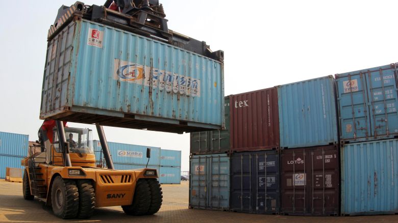 A forklift transfers a shipping container for export at a port in China's Jiangsu province in 2014.