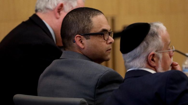 LONG BEACH, CA  -  APRIL 4, 2024 - - Eddie F. Gonzalez, 51, center, with lead attorney Michael Schwartz, right, and investigator Robert Dean, listen as a witness testifies during opening day proceedings in the trial of People vs. Eduardo Gonzalez in Dept. 21 at the Gov. George Deukmejian Courthouse in Long Beach on April 4, 2024. Gonzalez, a former Long Beach school safety officer shot an unarmed 18-year-old in the head near a high school in September 2021. Eddie F. Gonzalez, 51, fired into a fleeing vehicle in late September after a fight between Manuela "Mona" Rodriguez and an unidentified 15-year-old girl one block from Millikan High School. (Genaro Molina/Los Angeles Times via Getty Images)